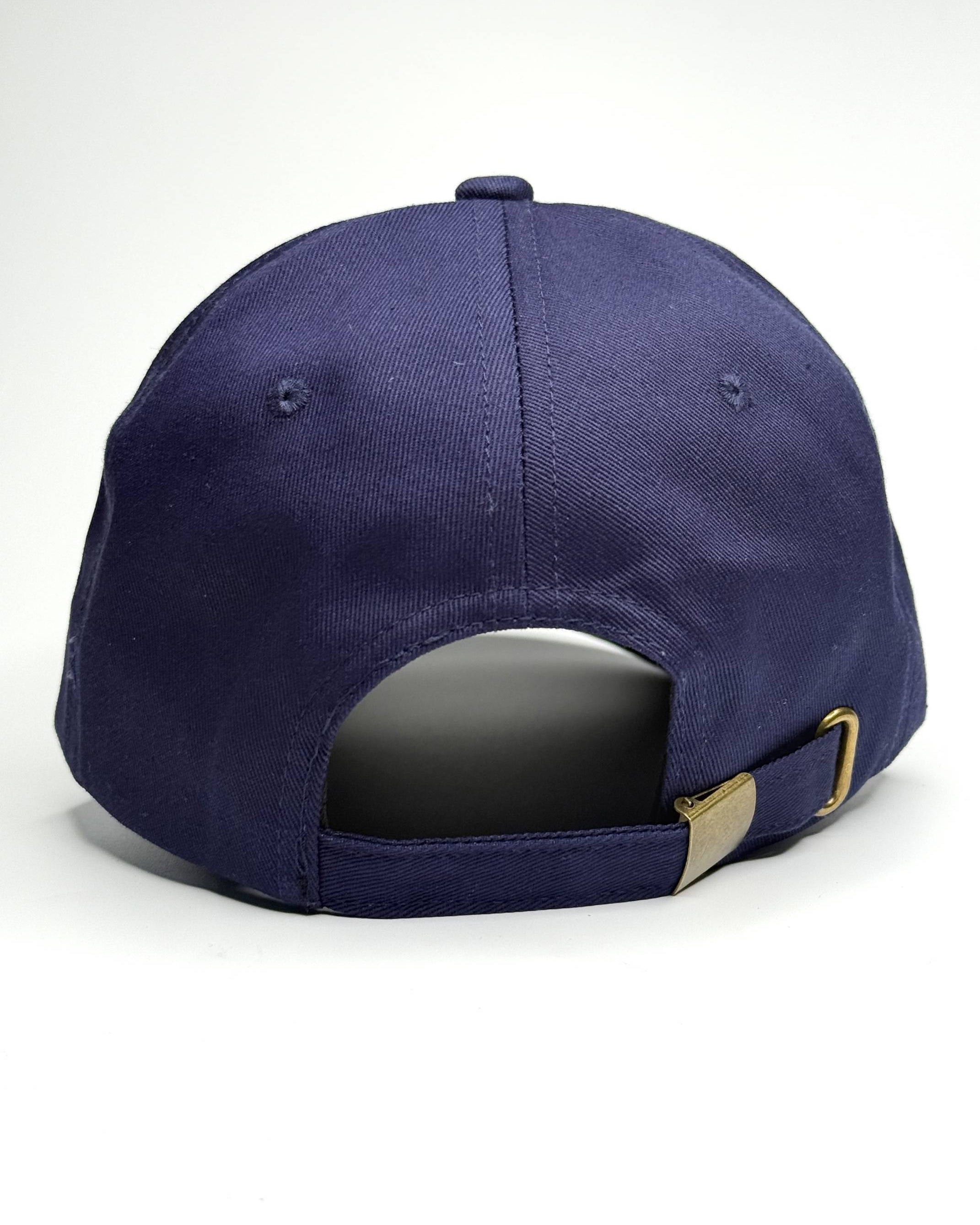 Navy blue baseball cap with a gold buckle on a white background