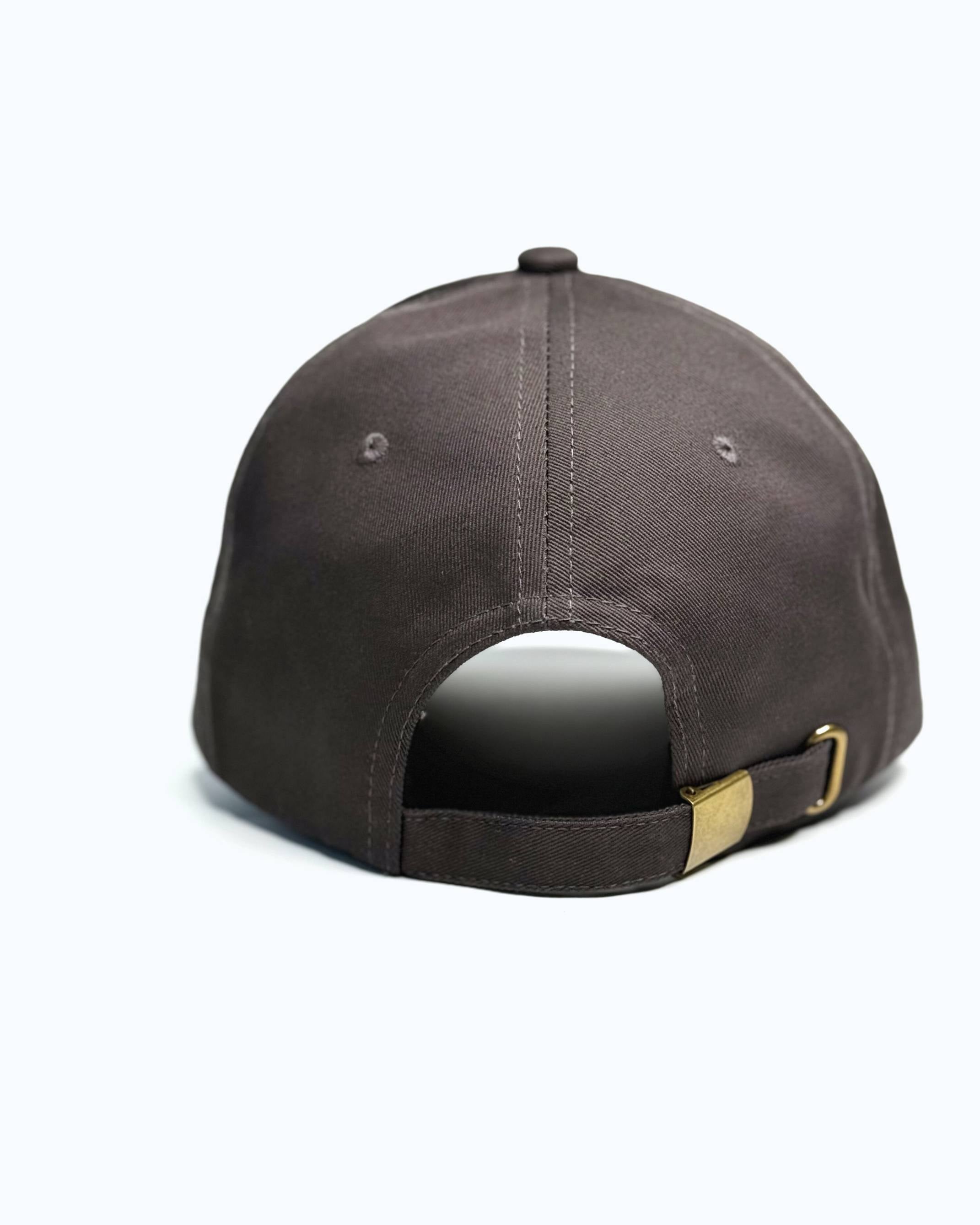 Brown baseball cap with a gold buckle on a white background