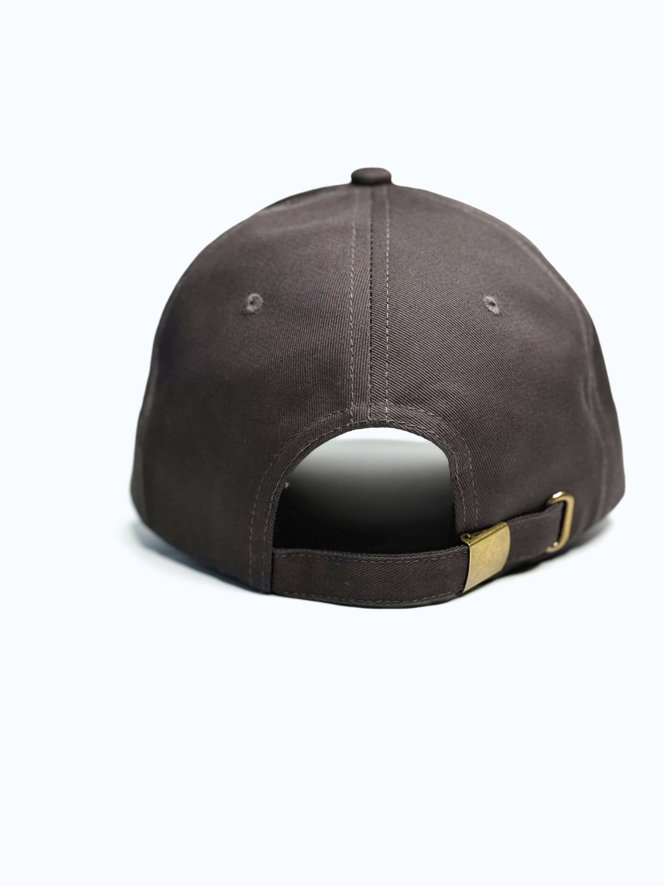 Brown baseball cap with a gold buckle on a white background