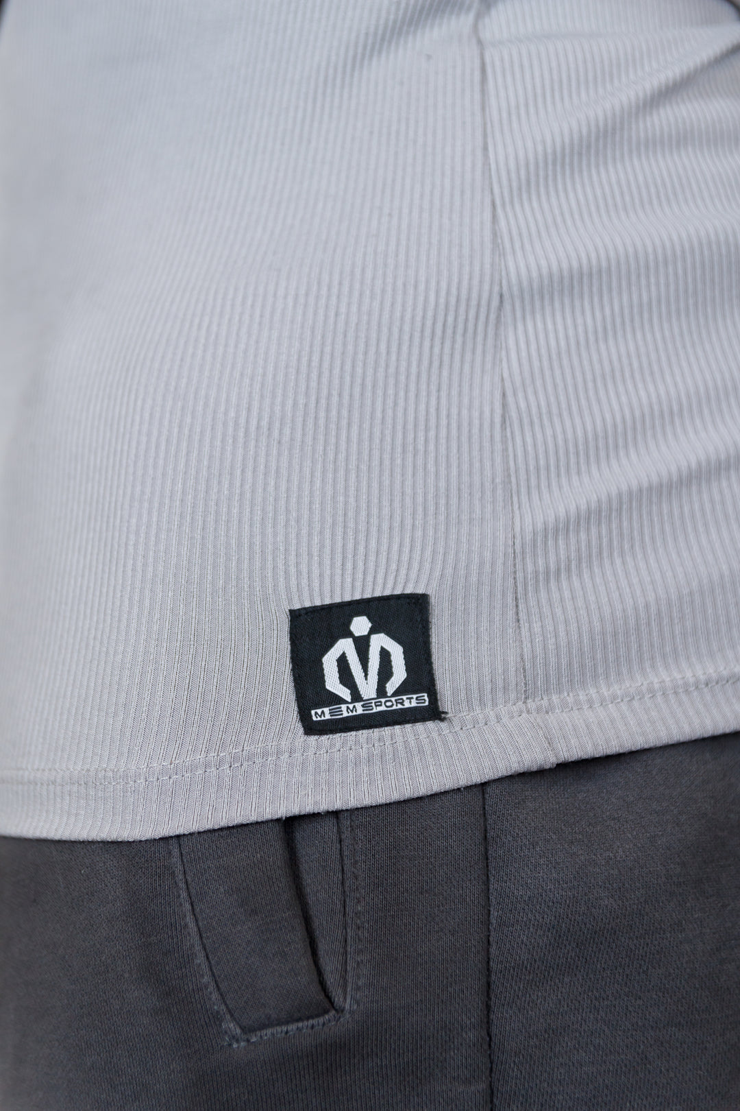 Close-up of a gray garment with a brand logo on a white background