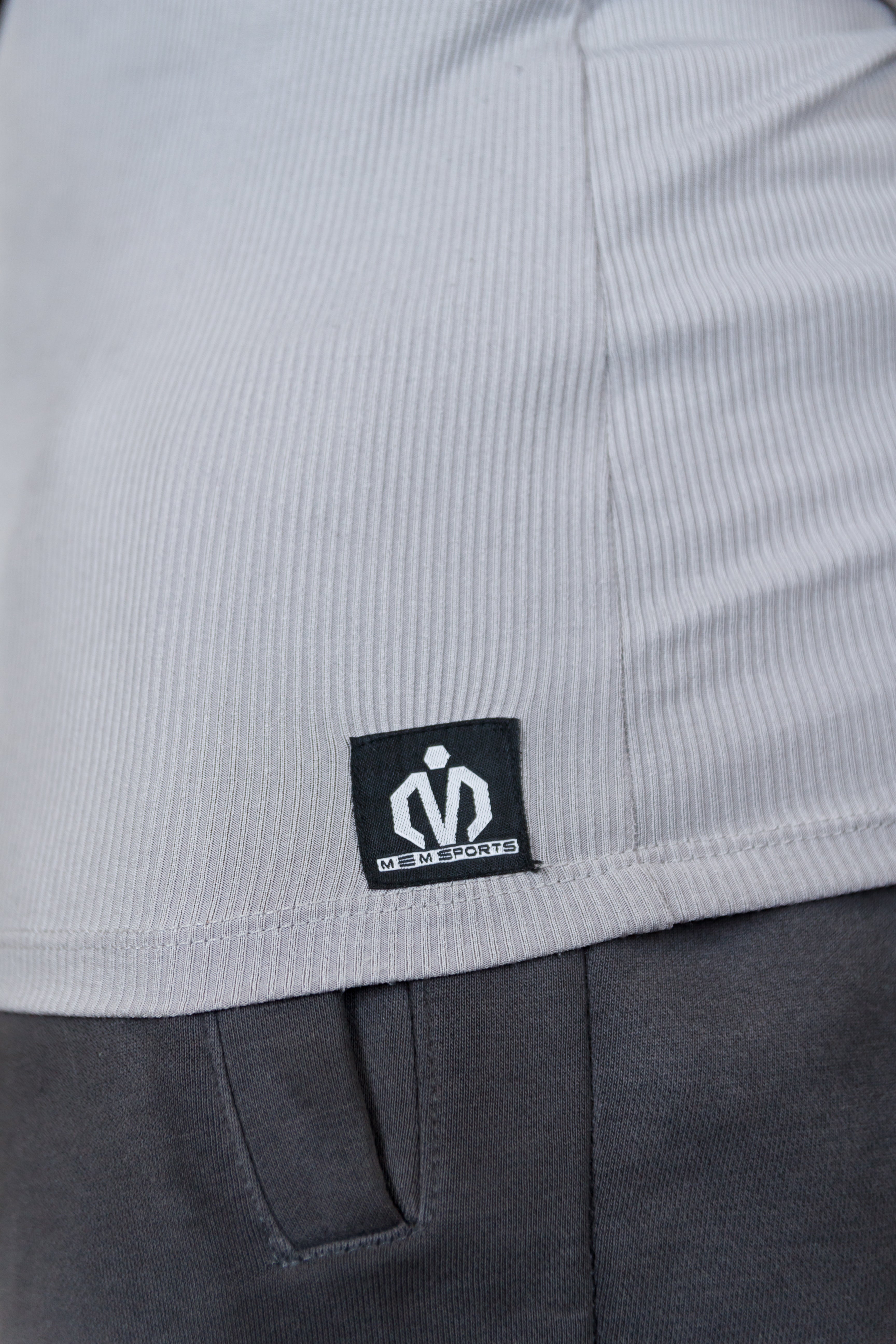 Close-up of a gray garment with a brand logo on a white background