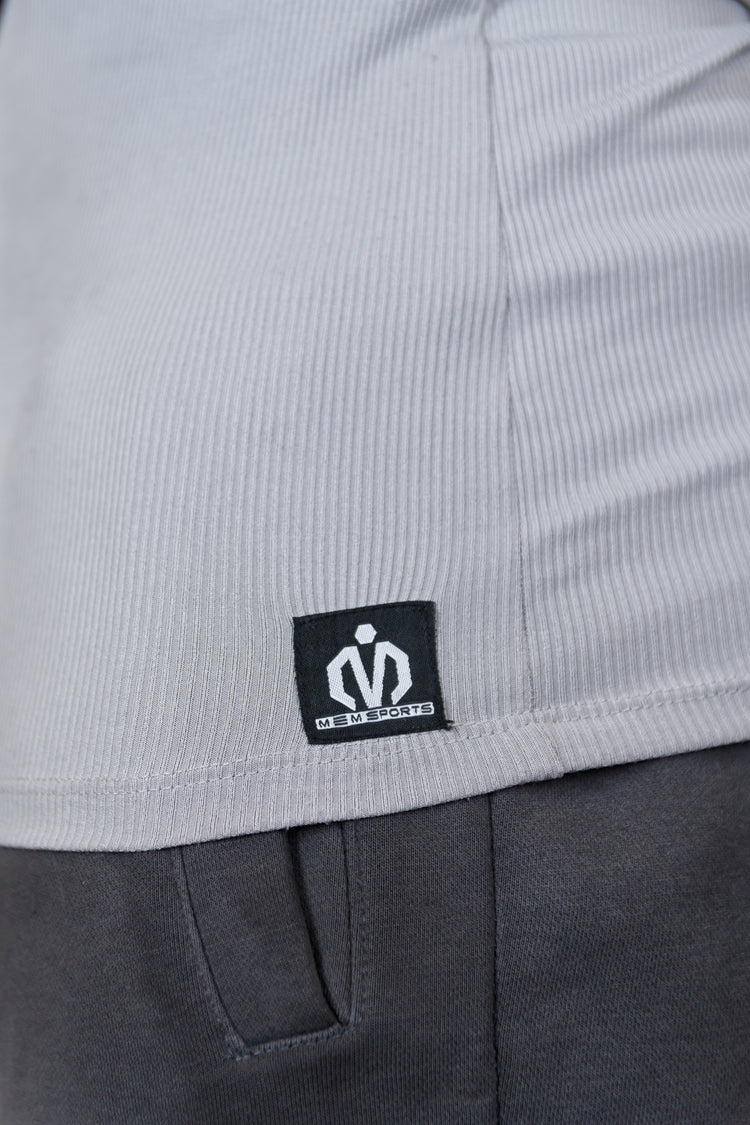 Close-up of a gray garment with a brand logo on a white background