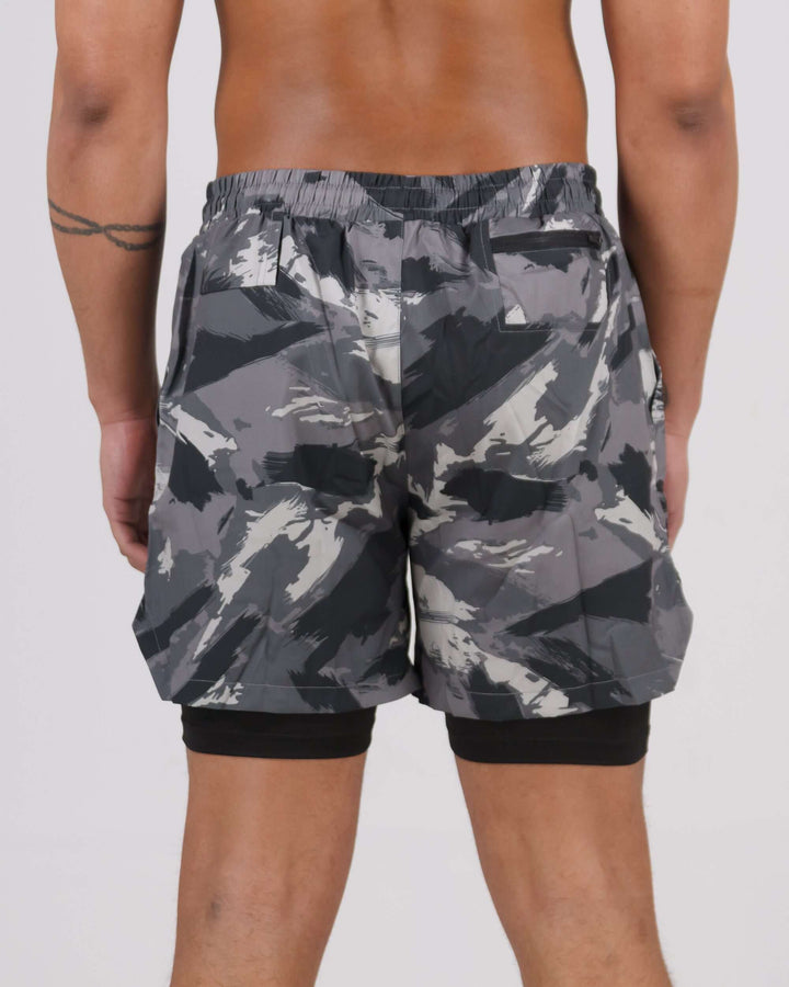 Rear view of grey camouflage Pinnacle Dry-Fit 2-in-1 Shorts with innovative compression design, worn by a male model.